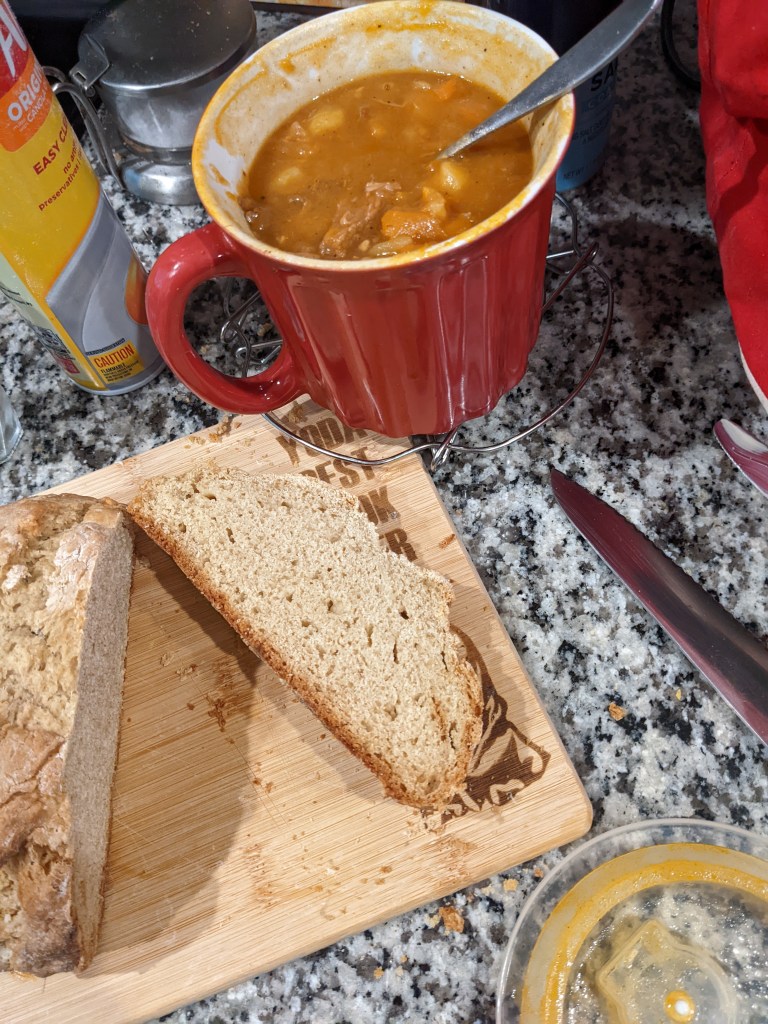 A picture of my soda bread all baked and sliced on my Yoda cutting board. Bread goes great with my beef stew recipe, which is also pictured to the upper right, in my favorite giant red soup mug.